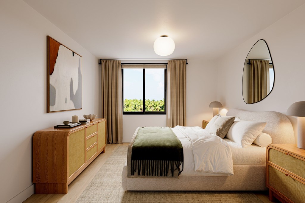 a bedroom with a bed and a mirror on the wall