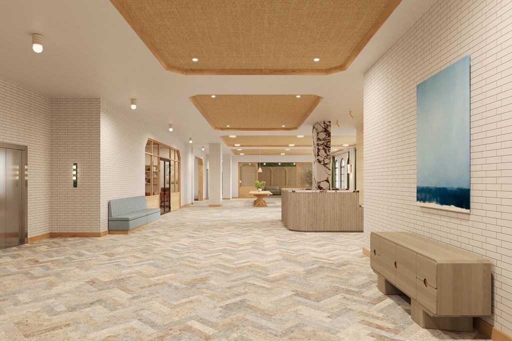 a lobby with a reception desk and a painting on the wall