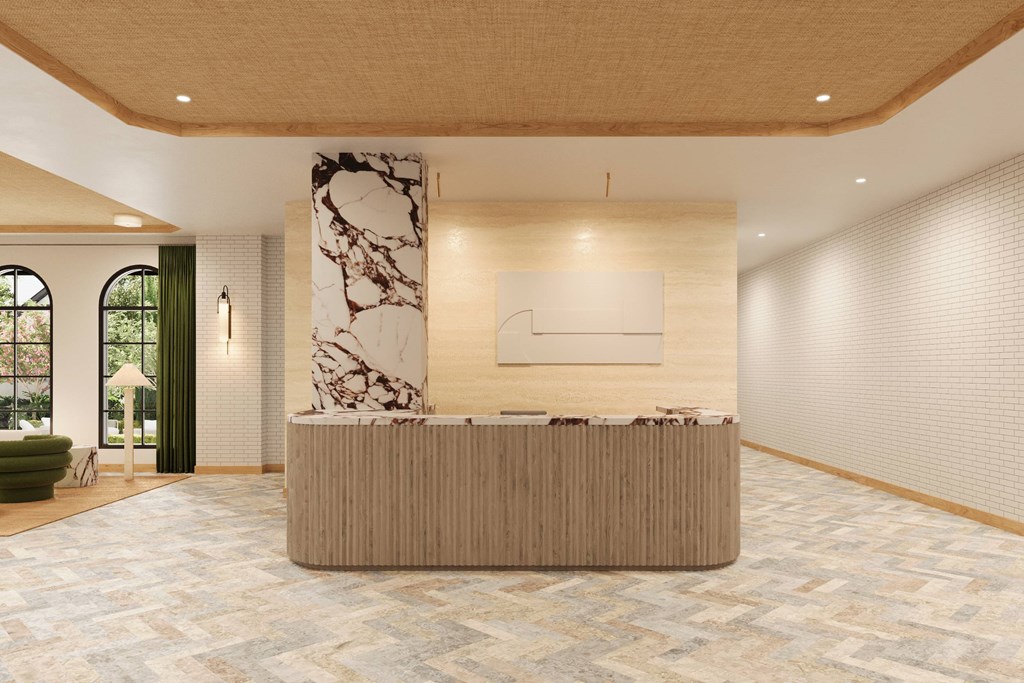a lobby with a reception desk and a marble wall