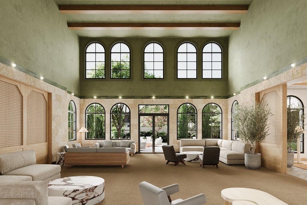 a living room filled with furniture and large windows