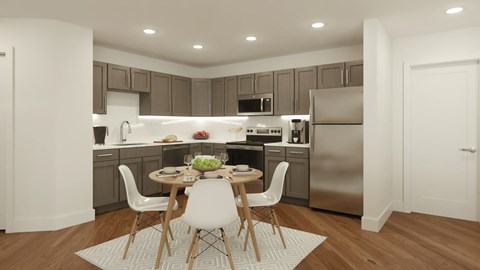 A modern kitchen with a dining table set for two.
