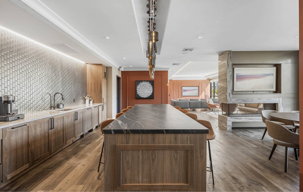 a kitchen with a large island and a living room with a fireplace