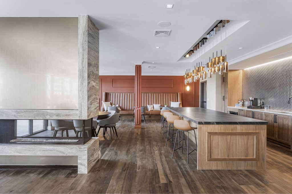 a dining room with a bar and a table with chairs