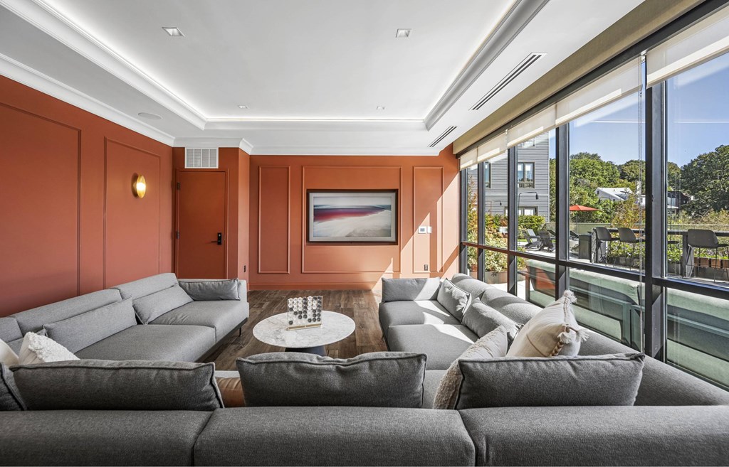 a living room with orange walls and a couch and a table
