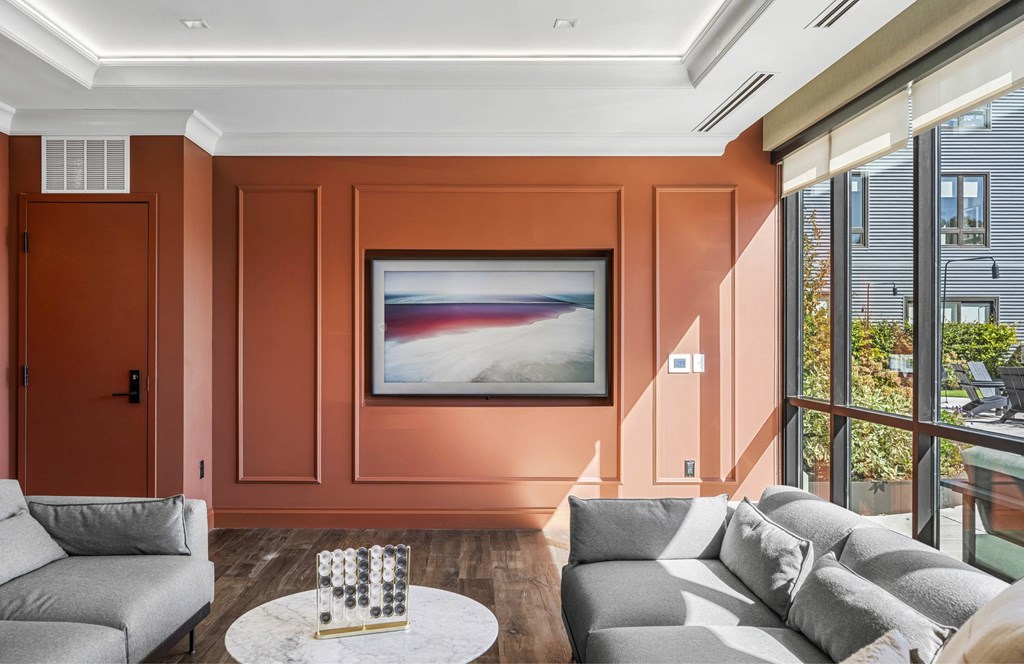 a living room with orange walls and a couch and a table