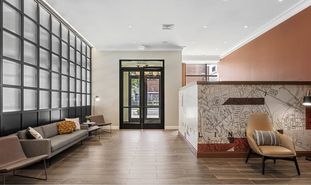 a lobby with couches and chairs and a wall with a mural