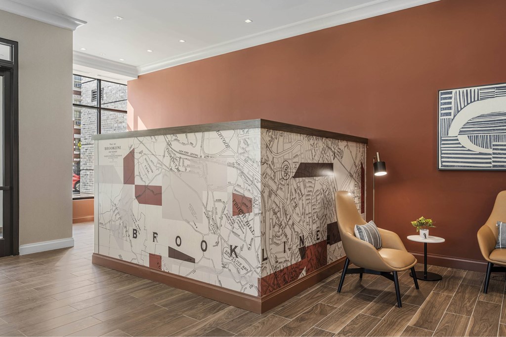 a lobby with a wall with a mural and chairs