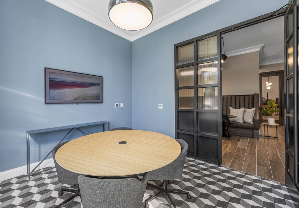a dining room with blue walls and a table and chairs