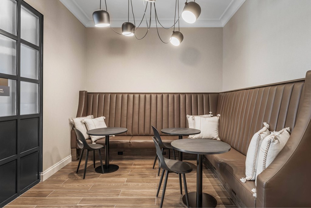 a dining room with tables and chairs and a large window