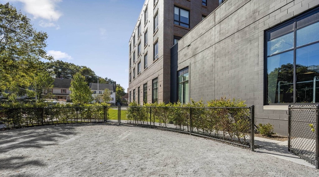 the yard of a building with a fence and a wheelchair ramp