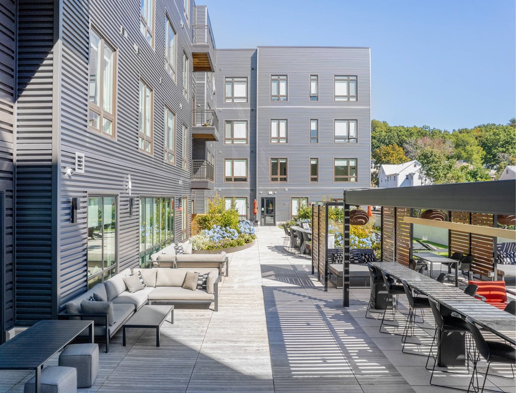 a rendering of a patio with tables and chairs