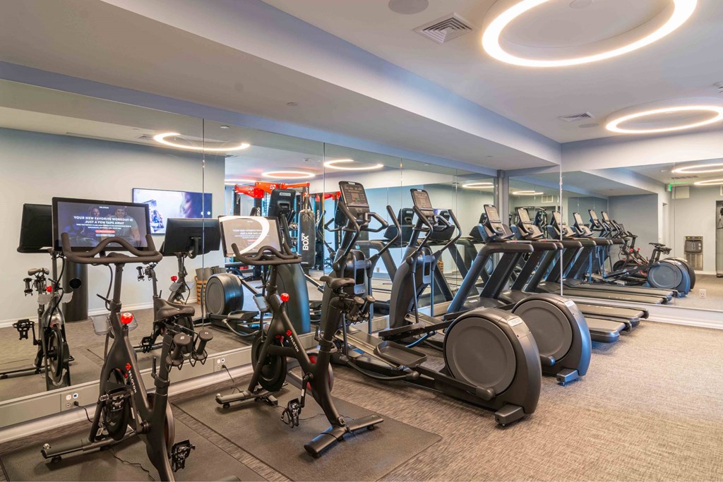 a gym full of cardio equipment in a building