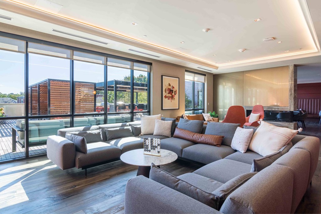 a living room with a gray couch and a table     and a