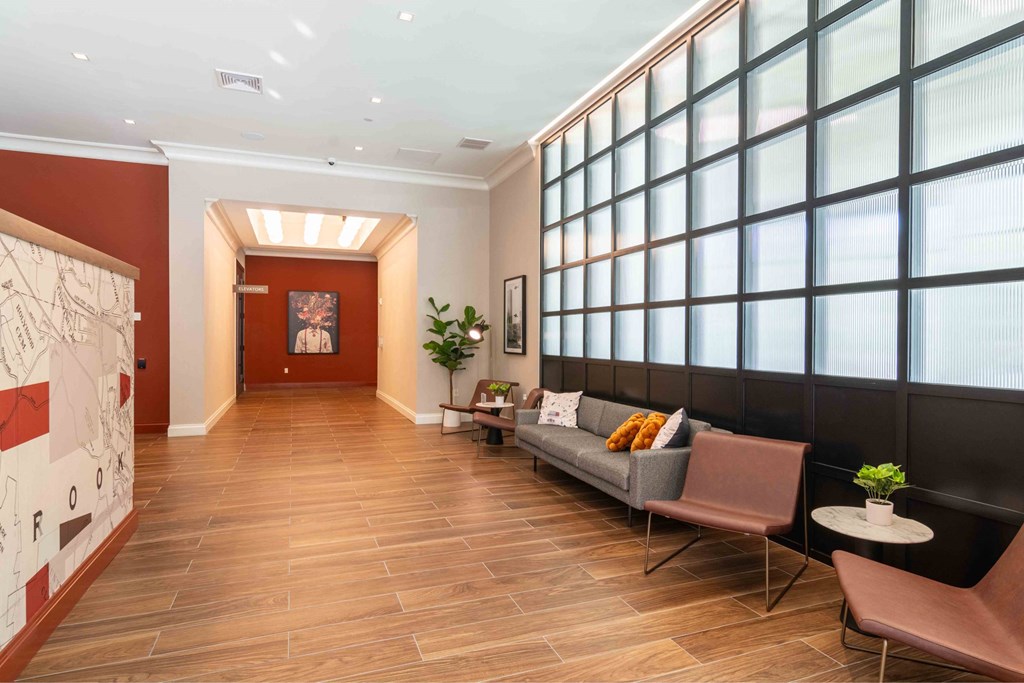 a living room with a couch and a wall of windows
