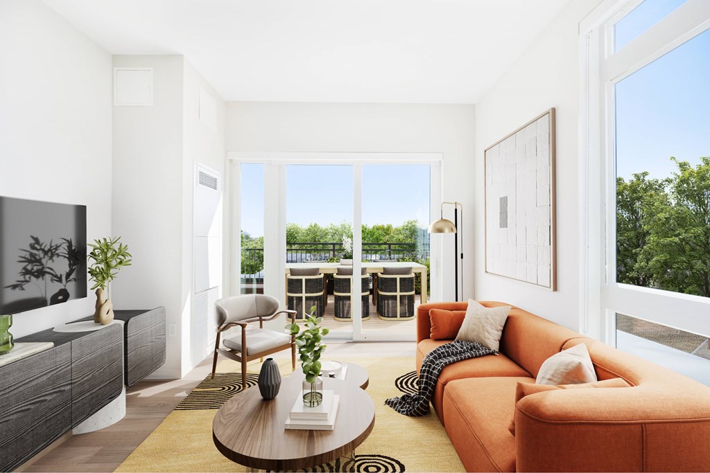 a living room with a couch and a table   and a balcony