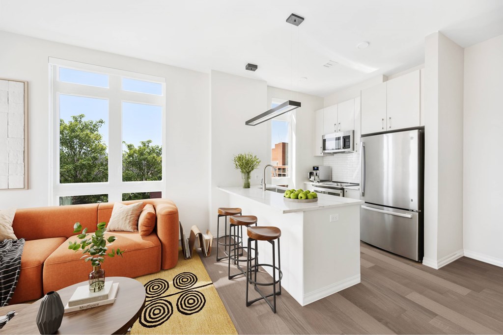 a living room with a couch and a kitchen