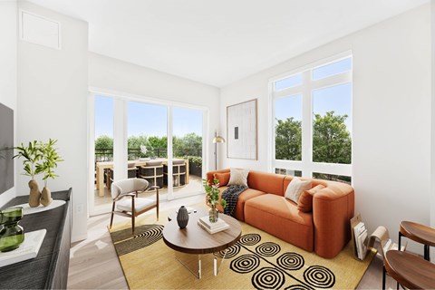 A living room with a brown sofa and a coffee table.