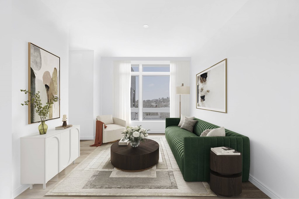 a living room with a green couch and a window