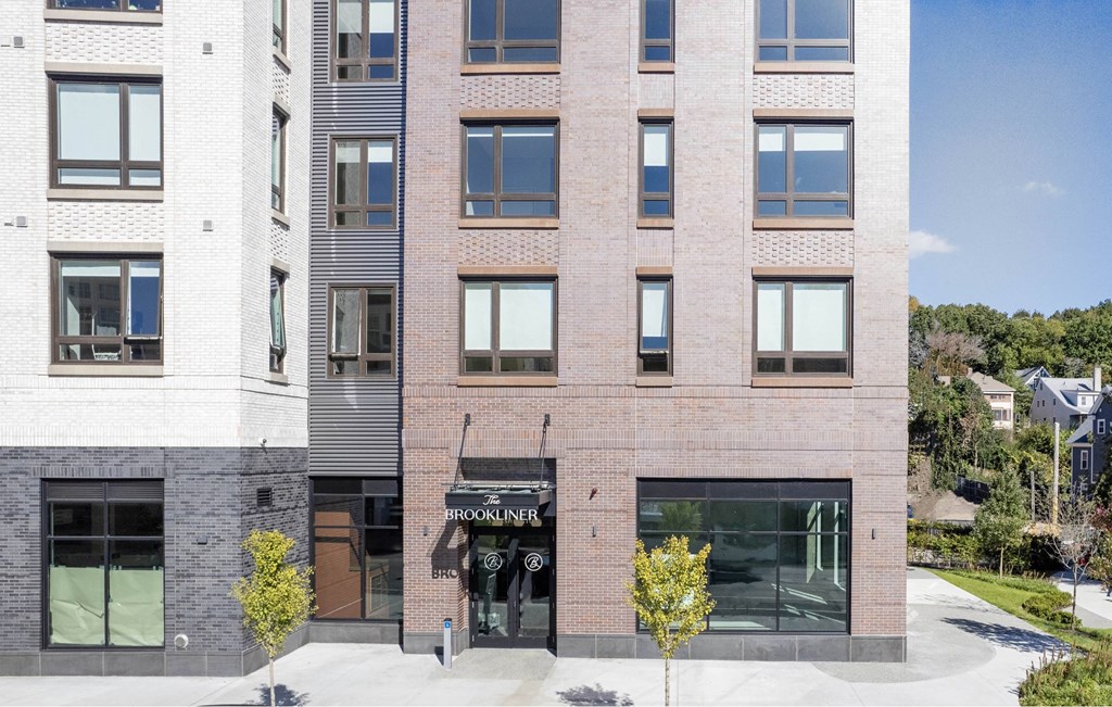 a brick building with a sidewalk in front of it