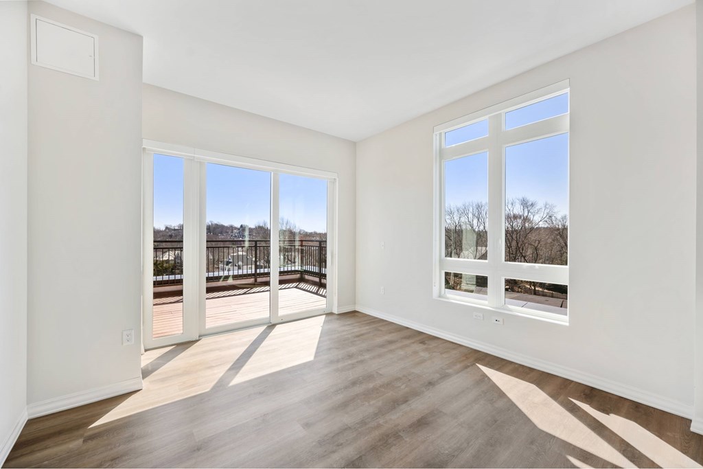a living room with large windows and a balcony