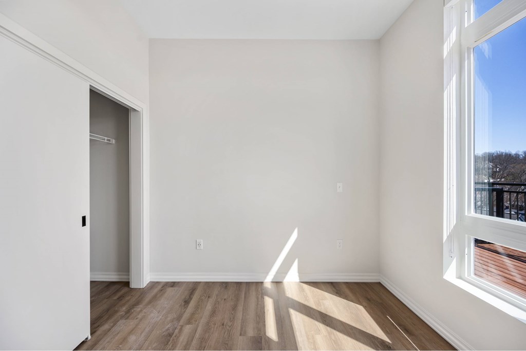 a living room with white walls and a window