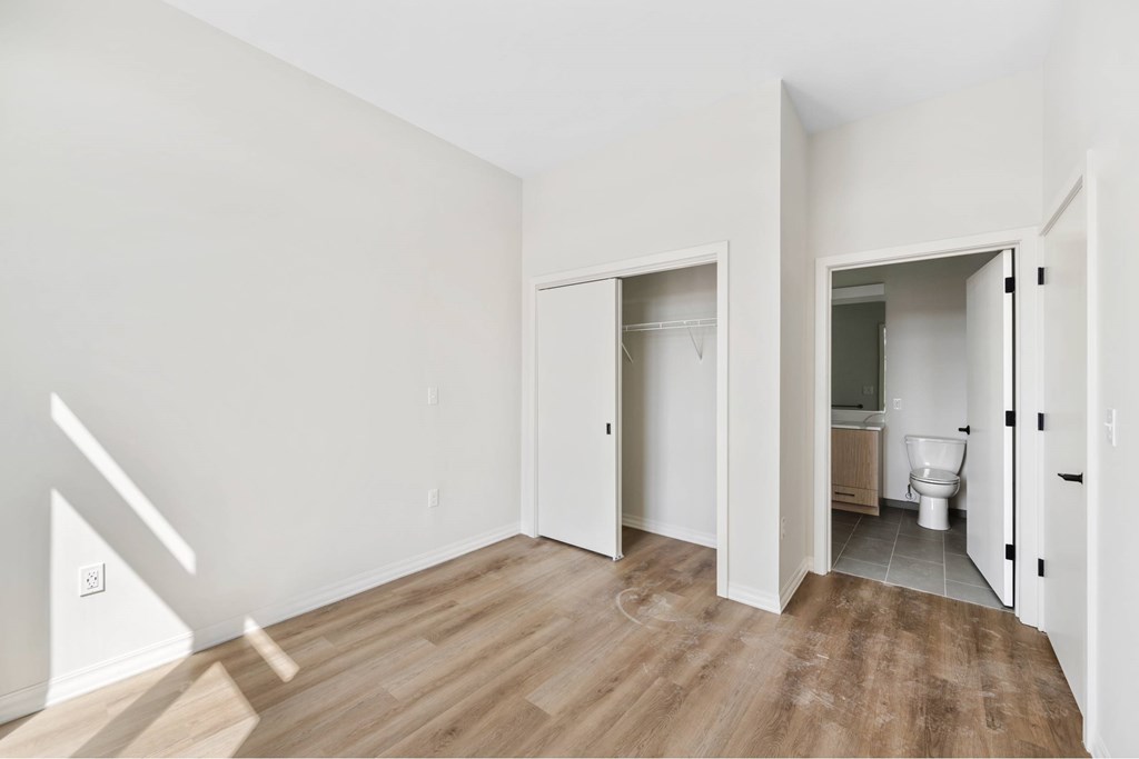 a living room with a toilet and a door to a bathroom