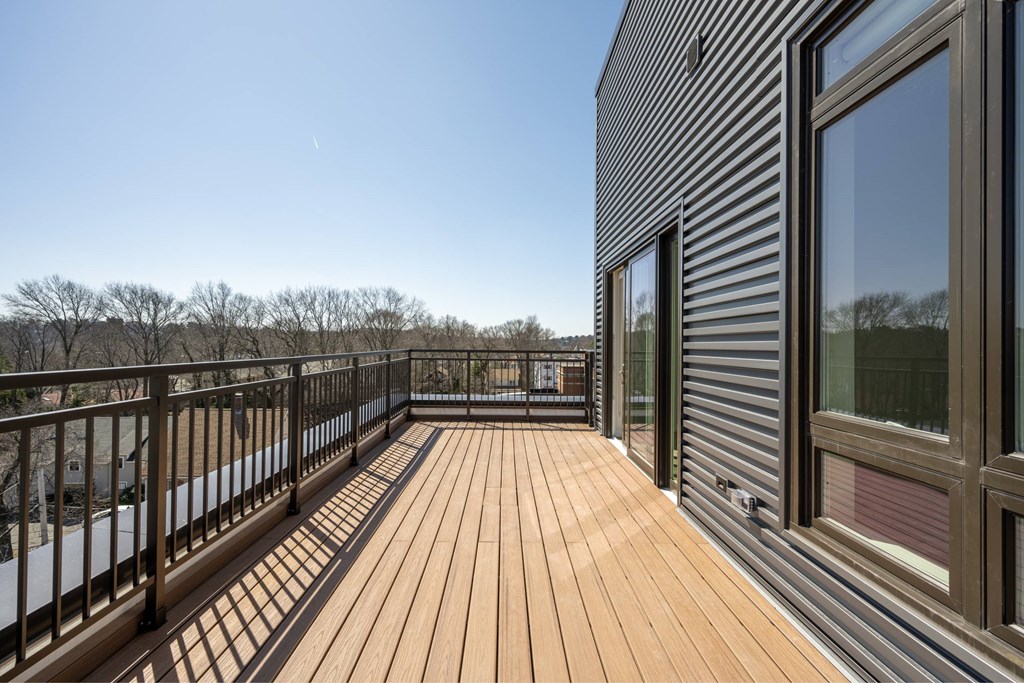 the deck of the home has views of the river and trees