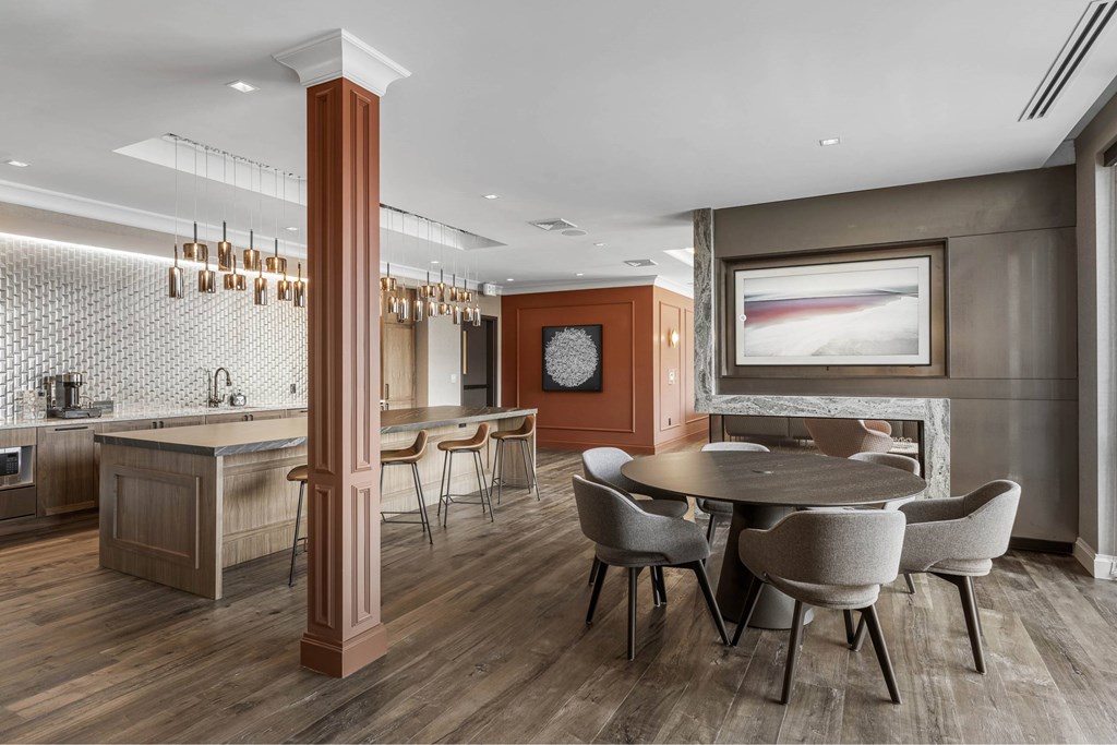 a dining room with a table and chairs and a kitchen