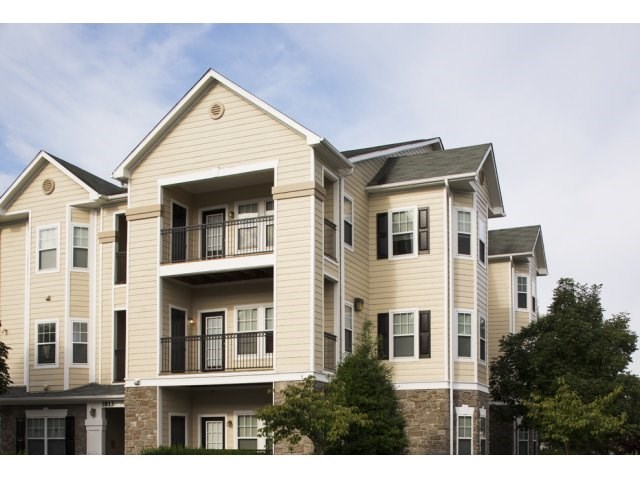 an image of an apartment building with a blue sky in the background