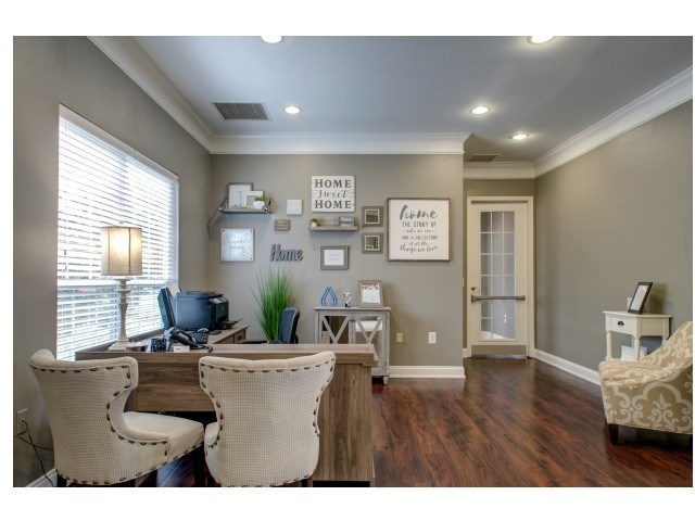 a home office with a desk and chairs