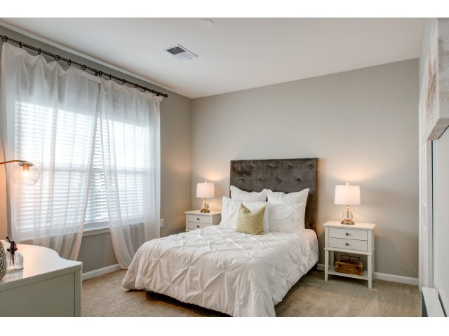 a bedroom with a large bed and a window