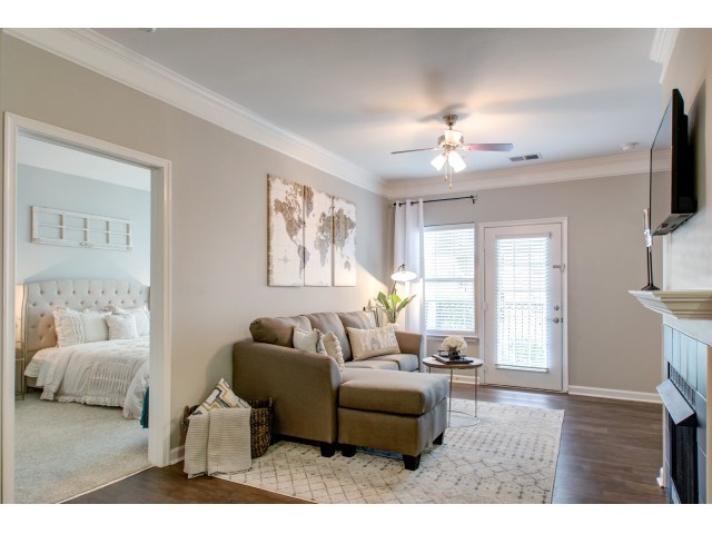 a living room with a couch and a door to a bedroom