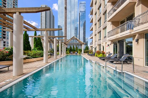 a swimming pool with a city skyline in the background