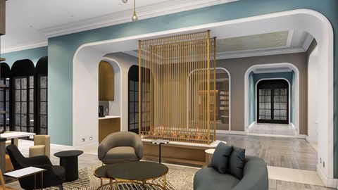 A living room with a grey sofa and a round table.