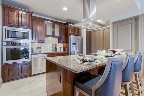 A modern kitchen with a dining table set for four.