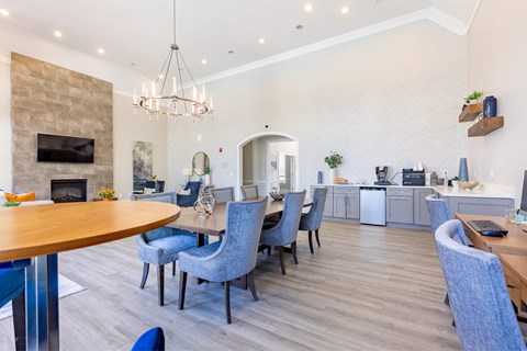 a dining room with blue chairs and a table and a fireplace