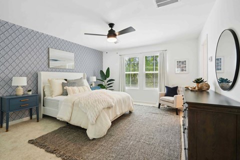 a bedroom with a bed and a ceiling fan