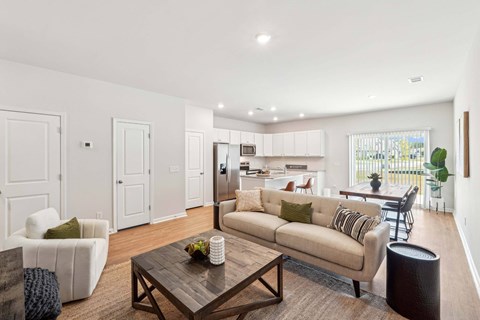 A living room with a white couch and a coffee table.