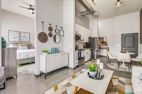 A modern kitchen with a white refrigerator and a dining table with chairs.
