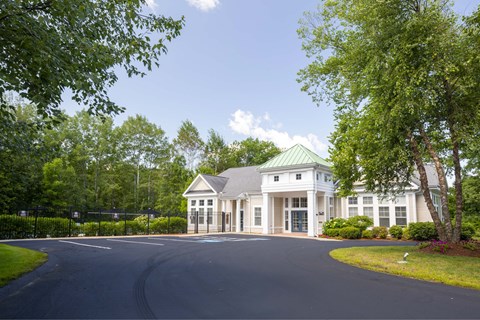 a large white building with a road in front of it