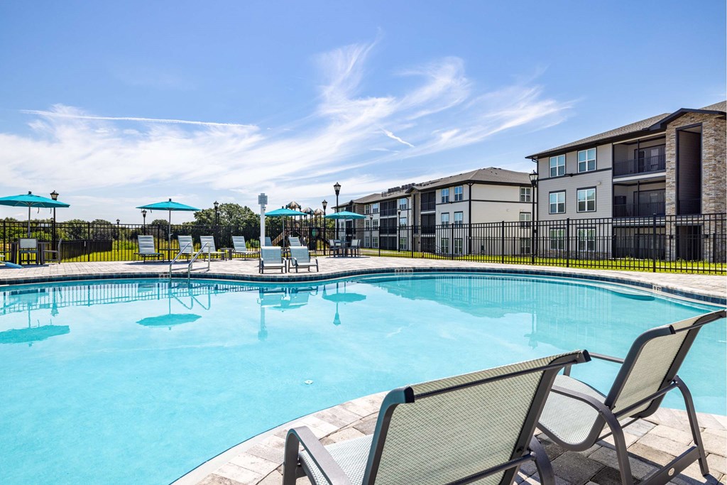 our apartments offer a swimming pool with chairs and umbrellas