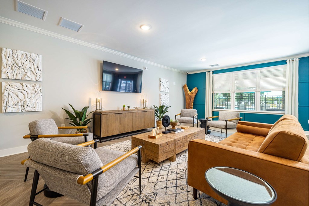 a living room with couches and chairs and a tv