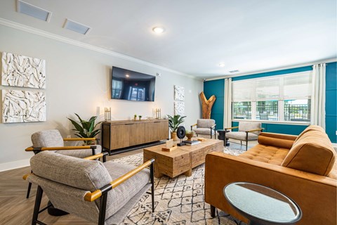 a living room with couches and chairs and a tv