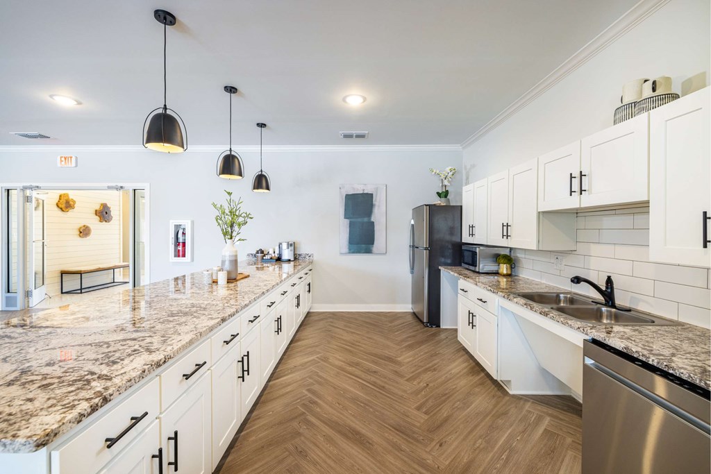 a large kitchen with marble counter tops and stainless steel appliances
