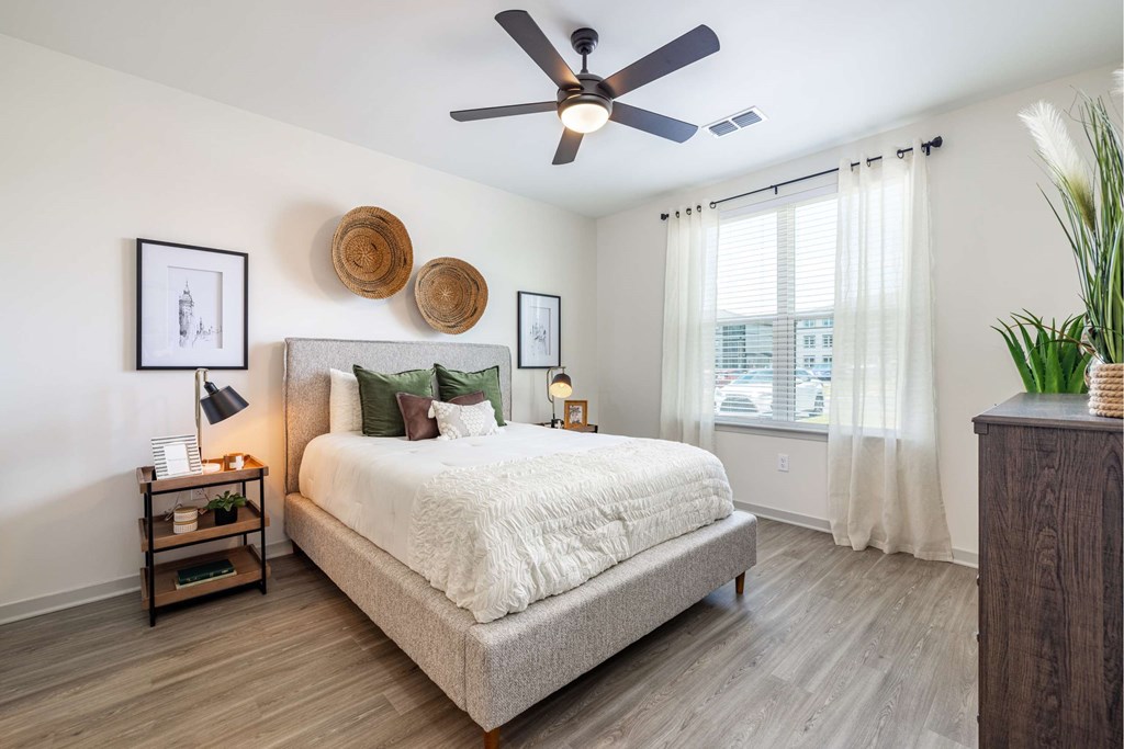 Cozy bedroom with ceiling fan and attached private bathroom at The Groves at Lake Juliana Cozy bedroom with ceiling fan and attached private bathroom at The Groves at Lake Juliana