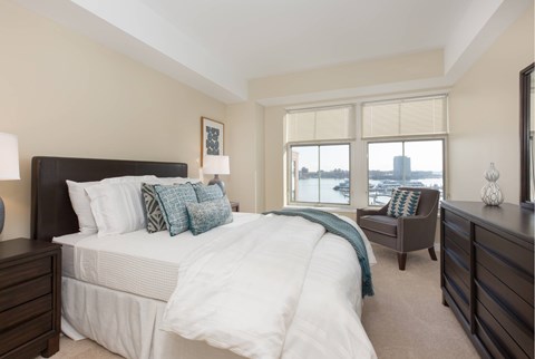 a bedroom with a large bed and a window