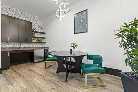 a dining room with a table and chairs and a kitchen