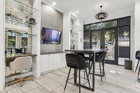 A modern kitchen with a dining table and chairs.