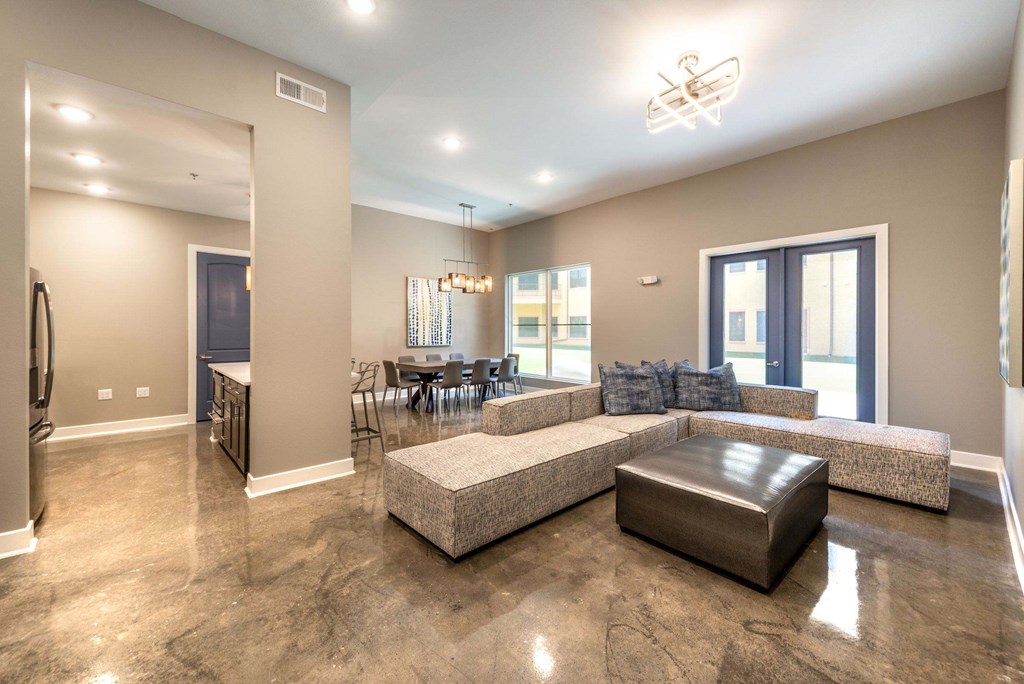 A spacious living room with a large couch and a coffee table.