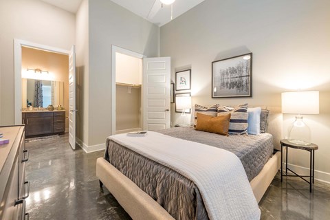 A bedroom with a large bed and a fireplace.